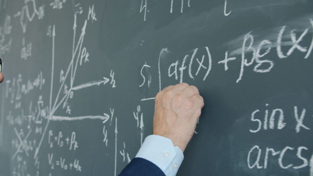 Mathematical equations written on a chalkboard, illustrating the inversion principle in problem-solving